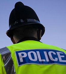 Photo of the back of a policeman in uniform